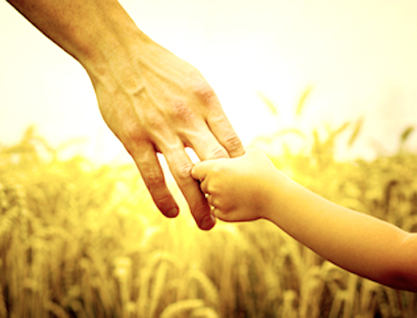 Child and Fathers Hand wheatfield