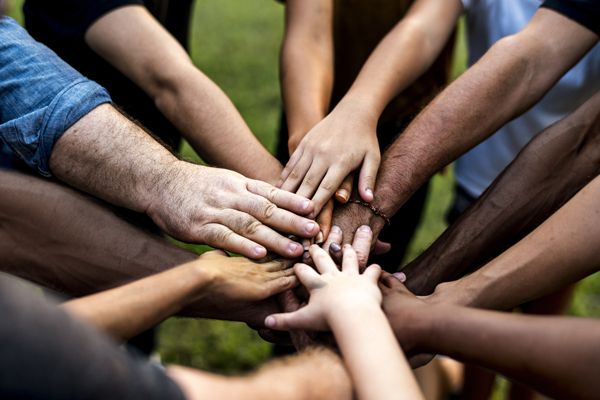 Group of people holding hand assemble togetherness Credit: Rawpixel Ltd. stock.adobe.com #165028946 | New Testament Christian Churches of America, Inc.