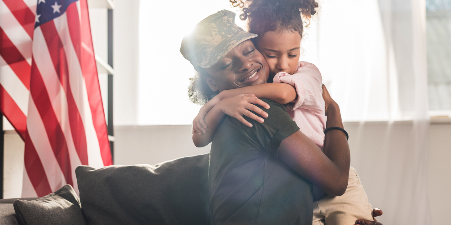 NTCC Military mom and daughter - Title: Female soldier in camouflage clothes and her daughter embracing on sofa | ©LIGHTFIELD STUDIOS - AdobeStock-201027185 | New Testament Christian Churches of America, Inc.