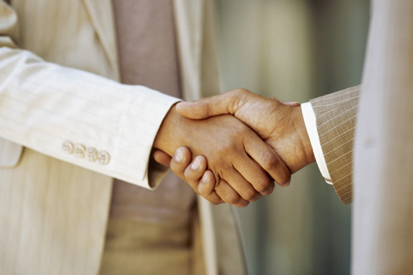 42-16033696  close-up of a businessman shaking hands with a businesswoman --- Image by © Royalty-Free/Corbis© Corbis.  All Rights Reserved.